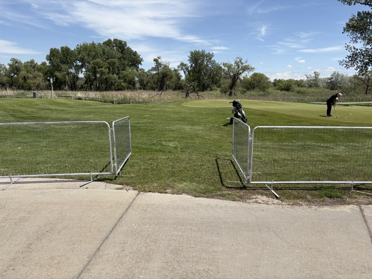 Free-standing fence panels managing access to a putting green at the Colorado Open