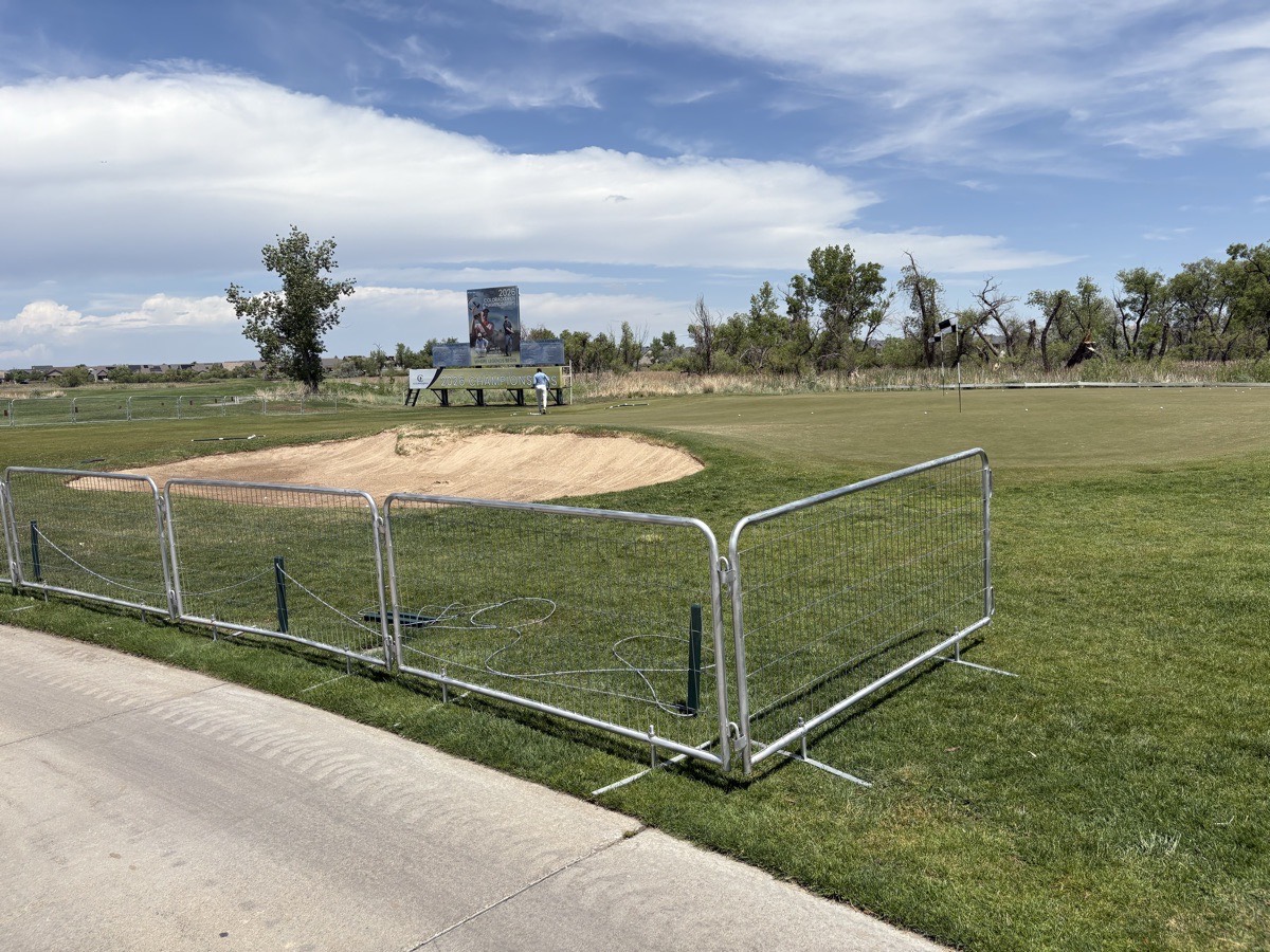 Temporary fence panels securing a greenside bunker at the Colorado Open