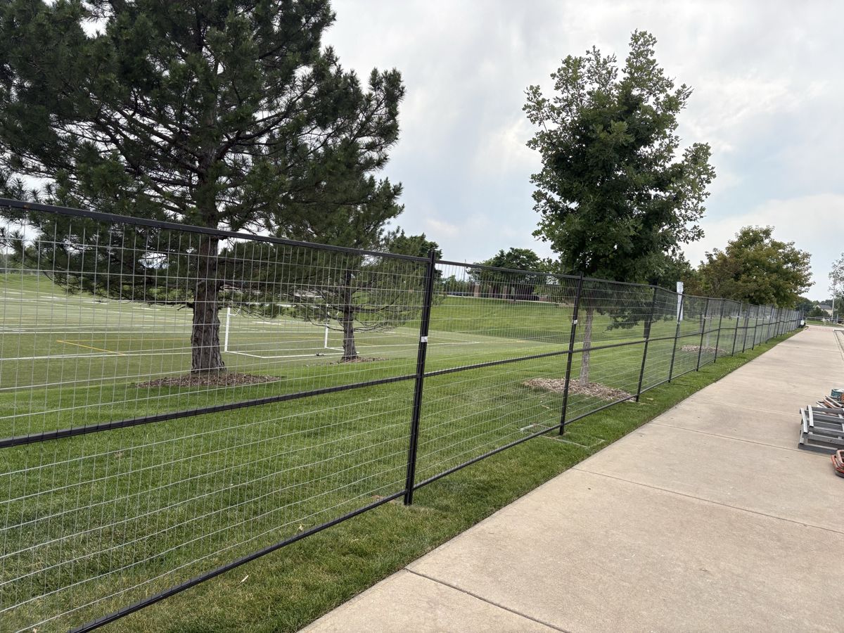 Tribute Fencing & Barricade temporary fence line running the length of a sports field